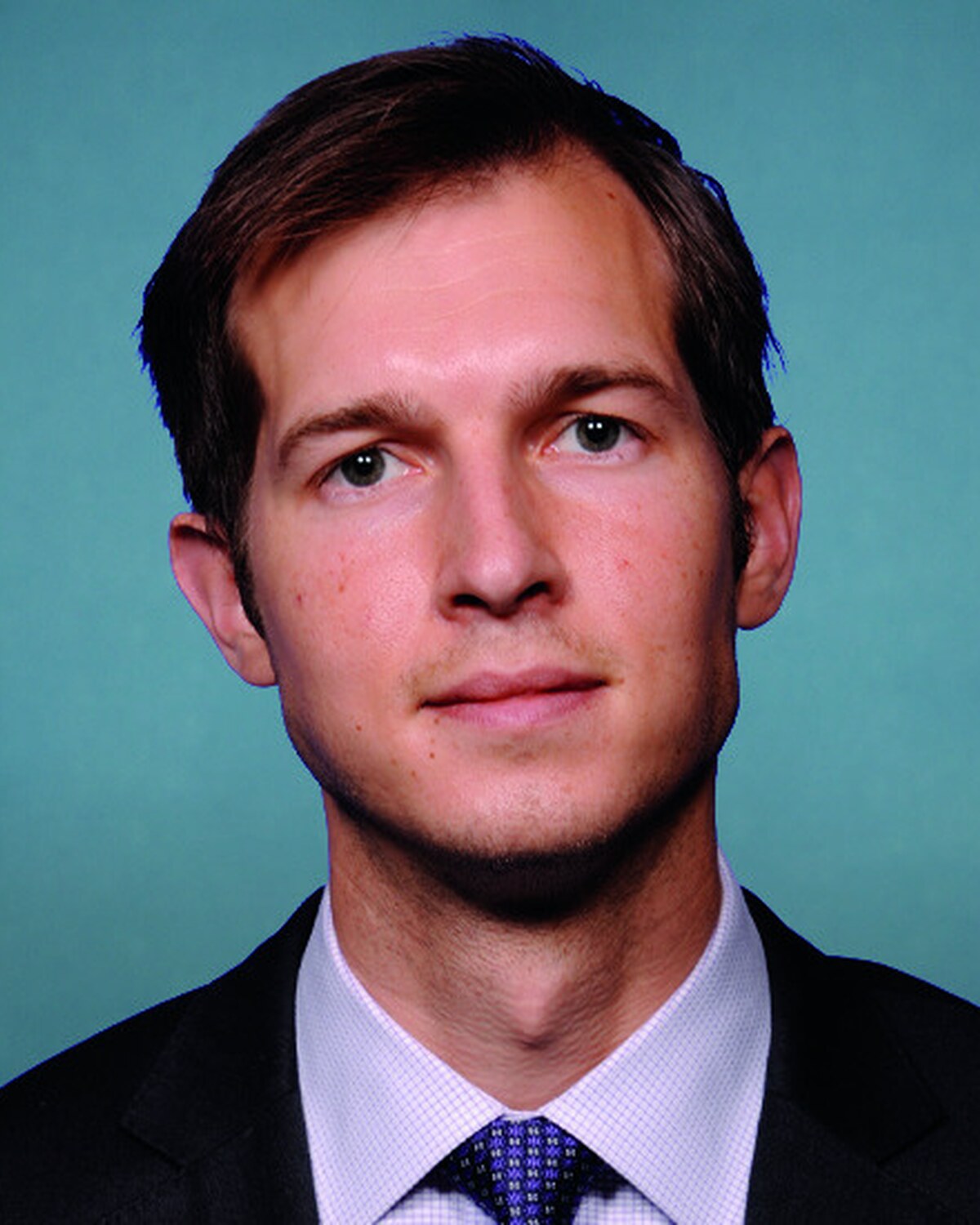 Official portrait of Jacob Daniel "Jake" Auchincloss, United States Representative for Massachusetts's 4th Congressional District.